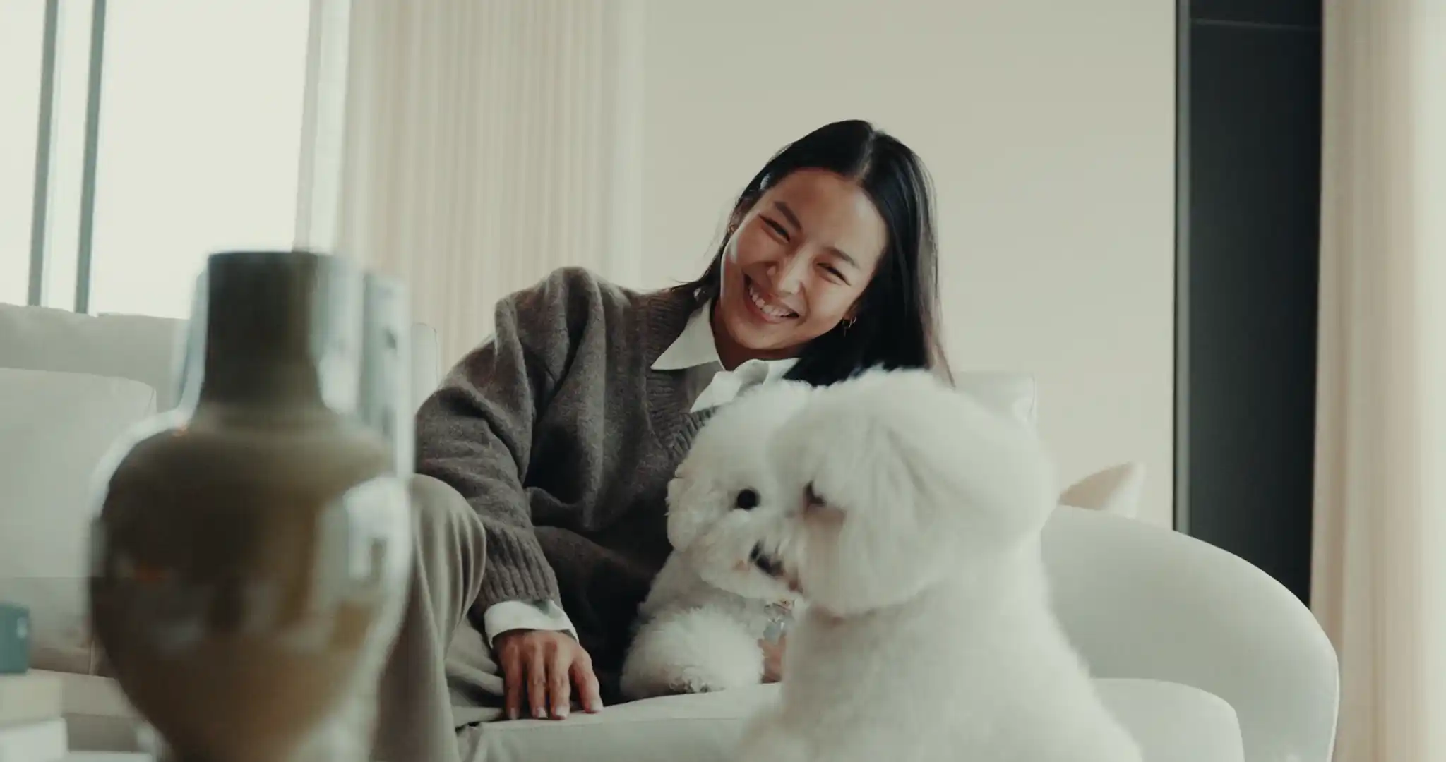 ผู้หญิงนอนเล่นที่โซฟากับสุนัขในคอนโดเลี้ยงสัตว์ได้